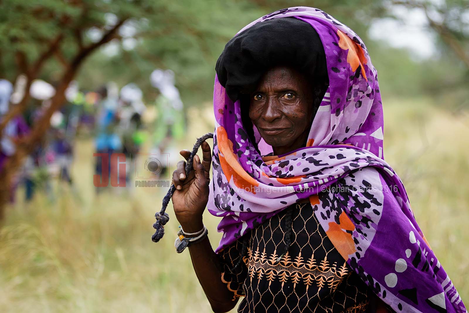 Woman from the Bororo tribe chasing her donkey