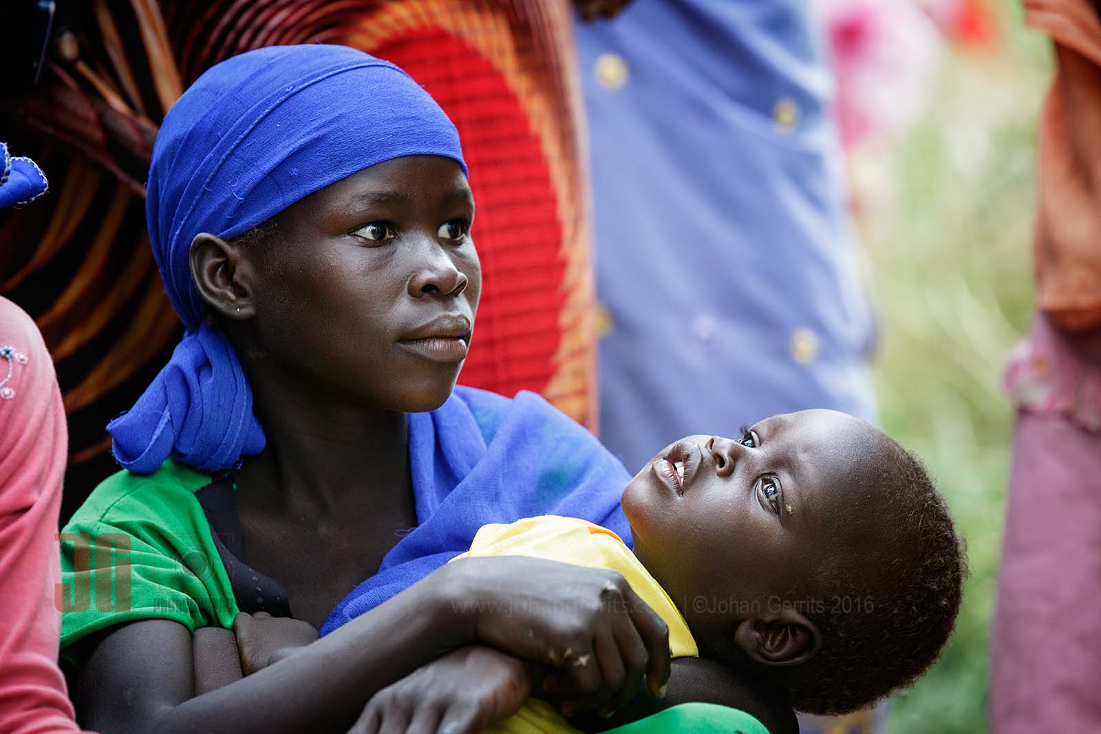 Caring for her little brother, while watching a traditional dance in Bitkine, a small city in the center of Chad.